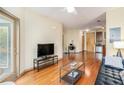 Spacious living room with hardwood floors, home office, and views into the kitchen at 898 Oak Sw St # 3420, Atlanta, GA 30310