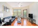 Bright living room with hardwood floors, black leather sofa, and abundant natural light at 898 Oak Sw St # 3420, Atlanta, GA 30310