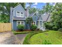 Inviting blue home with a well-maintained yard and a charming walkway leading to the front entrance at 233 Spence Se Ave, Atlanta, GA 30317
