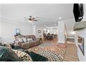 Cozy living area with a fireplace, ceiling fan, and hardwood floors at 3334 Swallowtail Ter, Duluth, GA 30096