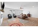 Bright living room with a ceiling fan, fireplace, and hardwood floors at 3334 Swallowtail Ter, Duluth, GA 30096