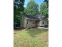Quaint one-story home with a cozy front deck nestled in a green, lush yard at 5119 Hill Farm Ne Dr, Woodstock, GA 30188