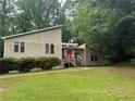 Angle view of the house showcasing the unique roof line and the red door at 6649 Valley Hill Sw Dr, Mableton, GA 30126