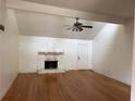 Open living room with hardwood floors, stone fireplace, and vaulted ceilings at 6649 Valley Hill Sw Dr, Mableton, GA 30126