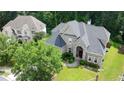 Aerial view of a brick two-story home with mature trees and landscaped front yard at 185 Beracah Sw Walk, Atlanta, GA 30331