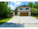 Lovely two-story home featuring stone accents, a modern garage door, and well-manicured landscaping at 2116 Strasburg Ct, Atlanta, GA 30338