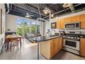 Open concept living area with kitchen featuring stainless steel appliances and lots of light at 5200 Peachtree Rd # 3420, Atlanta, GA 30341