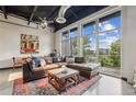 Stylish living room featuring a comfortable sectional sofa, large windows with a view, and a colorful area rug at 5200 Peachtree Rd # 3420, Atlanta, GA 30341
