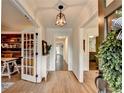Inviting foyer with beautiful hardwood floors, complemented by views of a stylish office and kitchen at 5285 Bannergate Dr, Johns Creek, GA 30022