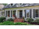 Inviting front entrance with brick steps, updated door, and beautiful black shutters for added curb appeal at 5285 Bannergate Dr, Johns Creek, GA 30022