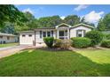 Charming single-story home featuring a well-manicured lawn and cozy front porch at 3274 Ridgecrest Se Rd, Smyrna, GA 30080