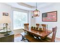Inviting dining room with a wooden table and chairs, complemented by an elegant light fixture at 3290 Cherry Oak Ln, Cumming, GA 30041