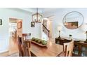 Bright dining room with a wood table, stylish decor, and easy access to the rest of the home at 3290 Cherry Oak Ln, Cumming, GA 30041