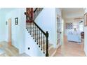 Bright foyer with staircase featuring decorative iron railings and hardwood floors leading into a cozy living area at 3290 Cherry Oak Ln, Cumming, GA 30041