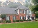 Beautiful brick home with a well-maintained lawn, complemented by lush landscaping at 3532 W Hampton Nw Dr, Marietta, GA 30064