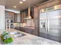 Gourmet kitchen with stainless steel refrigerator, and a large island with a sink at 1065 Peachtree Ne St # 3505, Atlanta, GA 30309