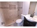 Modern bathroom features a tiled shower, sleek vanity, and contemporary fixtures at 128 Garden Walk, Stockbridge, GA 30281