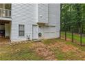 Backyard view showcasing the garage access, door, and landscaped surroundings at 2990 Cove Crossing Dr, Lawrenceville, GA 30045