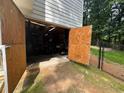 Spacious garage with large doors, offering ample storage and workspace, set against a fenced yard at 2990 Cove Crossing Dr, Lawrenceville, GA 30045