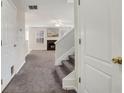 Welcoming entryway featuring carpeted floors, stairs, and view of the living room at 417 Red Coat Ln, Woodstock, GA 30188