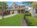 Well-maintained townhome with a garage, manicured lawn, and a neatly paved driveway at 417 Red Coat Ln, Woodstock, GA 30188