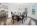 Formal dining room with a large wood table, chandelier, and bright windows at 2385 Saddle Brook Trce, Cumming, GA 30040