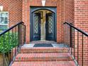 Inviting front entryway with a beautiful glass-paneled double door, steps and black railings at 2725 Bailey Ne Pl, Conyers, GA 30013