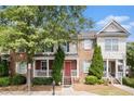 Charming townhome with brick facade, shutters, manicured shrubs, and a welcoming front porch at 3262 Cascade Parc Blvd, Atlanta, GA 30311