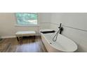 Modern bathroom featuring a sleek soaking tub and stylish fixtures at 4162 Riverdale Dr, Snellville, GA 30039
