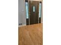 Stylish front door with decorative glass panels and hardwood flooring at 4162 Riverdale Dr, Snellville, GA 30039