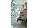 Inviting covered porch with comfortable wicker seating and beautiful views at 4162 Riverdale Dr, Snellville, GA 30039