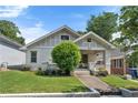 Inviting white brick bungalow with landscaped front yard and covered porch at 504 Angier Ne Ave, Atlanta, GA 30308