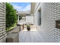 Charming side patio area with gray-toned pavers and white brick accent wall at 504 Angier Ne Ave, Atlanta, GA 30308