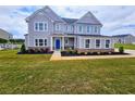 Beautiful two-story home with a well-kept lawn and blue door at 105 Marchmont Dr, Locust Grove, GA 30248