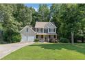 Charming two-story home with a well-manicured lawn, two-car garage, and a welcoming front porch at 14 Augusta Way, Hiram, GA 30141