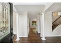 Elegant foyer featuring hardwood floors, white columns, and detailed trim work, creating a grand entrance at 14 Augusta Way, Hiram, GA 30141