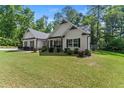 Beautifully landscaped home with an inviting front porch and manicured lawn at 2751 Pilgrim Mill Rd, Cumming, GA 30041