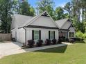 Beautiful home featuring a side entry garage, black trimmed windows and stylish landscaping at 2751 Pilgrim Mill Rd, Cumming, GA 30041