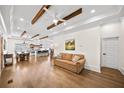 Open-concept living space with hardwood floors, exposed beams, and abundant natural light at 308 Reed St, Scottdale, GA 30079