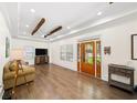 Bright and airy living room featuring hardwood floors, tray ceilings, and stylish furniture at 308 Reed St, Scottdale, GA 30079