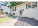 The house has a welcoming entrance with a landscaped front yard and a gray painted front door at 2825 Shea Sw Way, Marietta, GA 30060