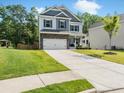 Charming two-story home with stone accents, attached garage, manicured lawn, and welcoming front porch at 340 Louise Ln, Canton, GA 30114
