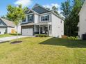 Charming two-story home with stone accents, attached garage, manicured lawn, and welcoming front porch at 340 Louise Ln, Canton, GA 30114