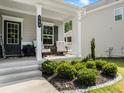 Inviting front porch featuring seating, manicured shrubs, landscaping stones, and decorative 'Welcome' sign at 340 Louise Ln, Canton, GA 30114
