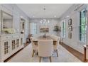 Bright and stylish dining room featuring elegant wainscoting, a large dining table, and a sparkling chandelier at 4250 Summit Dr, Marietta, GA 30068