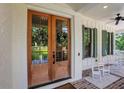 Elegant double front doors adorned with wreaths, complemented by green shutters and rocking chairs on the porch at 4250 Summit Dr, Marietta, GA 30068