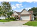 Well-maintained home features brick accents, vinyl siding, and an attached two-car garage at 3589 Garden Manor Dr, Loganville, GA 30052