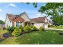 Beautiful home with manicured lawn and landscaping, featuring brick and vinyl siding at 3589 Garden Manor Dr, Loganville, GA 30052