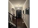 Elegant foyer with dark wood floors, decorative lighting, and a stunning double door entrance at 704 Kenton Ct, Locust Grove, GA 30248