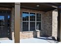 Inviting front porch and entryway features decorative columns and brick accents for a welcoming entrance at 920 Crescent Ridge Dr, Buford, GA 30518